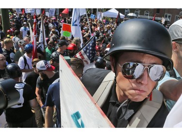 A white nationalist demonstrator with a helmet and shield walks into Lee Park in Charlottesville, Va., Saturday, Aug. 12, 2017.   Hundreds of people chanted, threw punches, hurled water bottles and unleashed chemical sprays on each other Saturday after violence erupted at a white nationalist rally in Virginia. At least one person was arrested.  (AP Photo/Steve Helber) ORG XMIT: VASH121
Steve Helber, AP