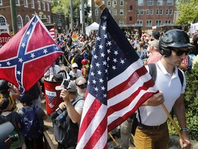 White nationalist demonstrators walk into Lee park surrounded by counter demonstrators in Charlottesville, Va., Saturday, Aug. 12, 2017. Gov. Terry McAuliffe declared a state of emergency and police dressed in riot gear ordered people to disperse after chaotic violent clashes between white nationalists and counter protestors. (AP Photo/Steve Helber) ORG XMIT: VASH118
Steve Helber, AP