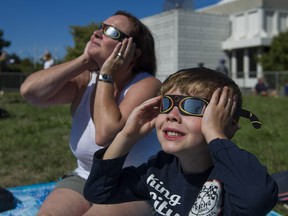 Logan Clyde and his mom TL watch the solar eclipse at the HR MacMillan Space Centre in Vancouver, BC, August, 21, 2017.