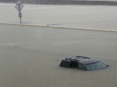 An abandoned vehicle sits in flood waters on the I-10 highway in Houston, Texas, Sunday, Aug. 27, 2017.