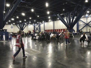 People seek shelter from the aftermath of Hurricane Harvey at the George R. Brown Convention Center in Houston on Sunday, Aug. 27, 2017. Rising floodwaters from the remnants of Hurricane Harvey chased thousands of people to rooftops or higher ground Sunday in Houston, overwhelming rescuers who fielded countless desperate calls for help.