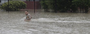A man wades through floodwaters from Tropical Storm Harvey Sunday, Aug. 27, 2017, in Houston, Texas.