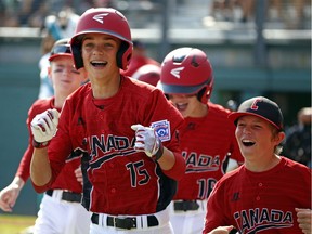 White Rock's Reid Hefflick (15) celebrates with teammates as he returns to the dugout after hitting a three-run home run off Maracaibo, Venezuela pitcher Dario Cardozo (16) in the first inning of an International pool play baseball game at the Little League World Series tournament in South Williamsport, Pa., Sunday, Aug. 20, 2017. Canada won 7-3.