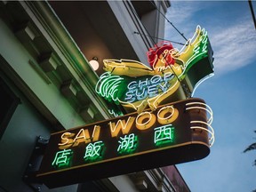 The replica of the original neon sign hanging outside Sai Woo.