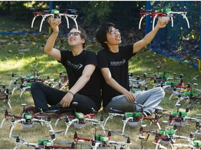 Zev Bertini, left, and Samuel Zhao hold up the drones that have replaced the fireworks capping a day at the Fair at the PNE. The evening show, called the Northern Light Sky show, runs 10:15 p.m. nightly at the PNE's Festival Park in Vancouver.