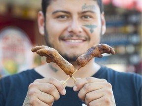 Billy Nanemahoo sells deep-fried chicken feet at the PNE fair in Vancouver.
