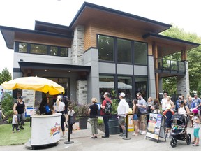 Fairgoers line up to tour the PNE prize home Wednesday .