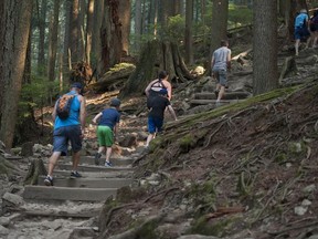 Hikers head up the popular Grouse Grind trail on Wednesday.