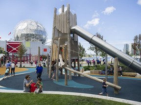 Children play at the recently opened Creekside Park Playground in Vancouver.