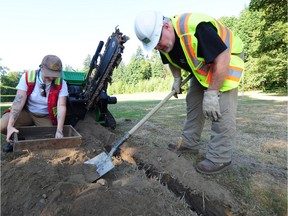 Geordie Howe, the first staff archaeologist employed by a municipality in Canada, at work with Ginevra Toniello of the Tsleil-waututh Nation in Stanley Park at Vancouver on July 26.