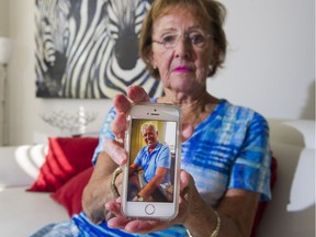 Anne Bennett holds a photo of her jailed husband John while at her home in North Vancouver.