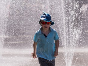 Arthur Morrison who is visiting from the UK runs through a spray park while enjoying a warm day in Vancouver, July, 31, 2017.