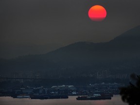 Sunset seen from Boundary Road as Environment Canada issues a weather advisory as winds carry smoke from wildfires burning in B.C.'s interior to the province's south coast in Vancouver, BC., August 2, 2017.