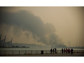 A warehouse fire on Annacis Island creates smoke as seen from New Westminster.