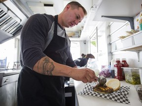 VANCOUVER,BC:AUGUST 20, 2017 -- Brian Jones of Gourmet Burger prepares a Cricket Burger during the 2017 PNE Fair in Vancouver, BC, August, 20, 2017. (Richard Lam/PNG) (For ) 00050318A [PNG Merlin Archive]
RICHARD LAM, PNG