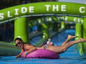 Sliders make their way down a 1000 foot water slide on Lonsdale Ave. while taking part in the Slide in the City event in North Vancouver, BC, August, 22, 2015. (Richard Lam/PNG) (For ) 00038607A [PNG Merlin Archive]
RICHARD LAM, PNG