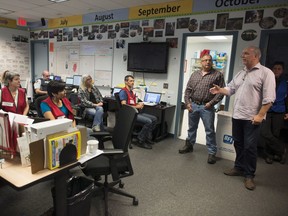 B.C. Premier John Horgan (right) tours the provincial regional emergency operations centre in Kamloops on Monday.