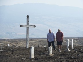 British Columbia Premier John Horgan walks though a bunt out cemetery with Chief Greg Blain in Ashcroft, B.C., Monday, August 28, 2017.