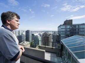 Ken Waters who is on the strata council at 889 Homer St. looks over the rails that are in dispute with a penthouse owner.