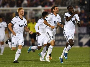 Vancouver Whitecaps midfielder Tony Tchani (16) (right) celebrates his goal in the first half of the match against the Colorado Rapids at Dick's Sporting Goods Park.