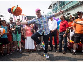 B.C. Premier John Horgan has been a lot happier since his New Democrats formed government. He was all smiles showing off his rainbow sneakers before marching in the Vancouver Pride Parade on Sunday, Aug. 6.