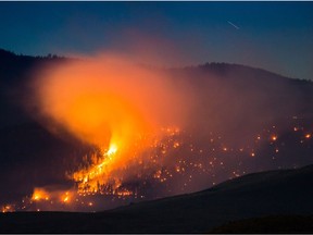 A wildfire burns on a mountain near Ashcroft, B.C., on July 7, 2017.