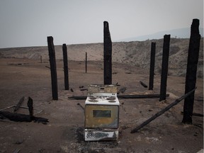 A stove sits among the remains of a home that burned in a wildfire on the Ashcroft First Nation.