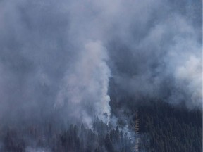 A body pulled from a settling pond at a pulp mill in British Columbia's southern Interior has been identified as that of a 67-year-old man who went missing after he was driven from his home by wildfires last summer. A wildfire is seen from a Canadian Forces Chinook helicopter as Prime Minister Justin Trudeau views areas affected by wildfire near Williams Lake, B.C., on Monday July 31, 2017.