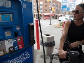 Deborah Vincent puts gas into her vehicle at a Toronto gas station on Thursday Aug. 31, 2017. A major hike in gas prices is expected over the next few days. THE CANADIAN PRESS/Doug Ives