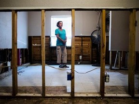 Julie Boon, director of Eudaimonia Recovery Homes poses for a photograph at one of her facility damaged by Hurricane Harvey on Friday, Sept. 8, 2017, in Houston. In the aftermath of flooded Houston, Julie Boon oversaw repairs at a sober-living home while giving advice to residents based on her own 30 years of sobriety. (AP Photo/Matt Rourke)