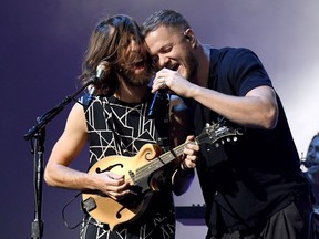 Guitarist Wayne Sermon (L) and frontman Dan Reynolds of Imagine Dragons perform during a stop of the band's Evolve World Tour at T-Mobile Arena on September 29, 2017 in Las Vegas, Nevada.