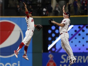 Francisco Lindor, left, and Jay Bruce of the Cleveland Indians celebrate after defeating the Baltimore Orioles on Sept. 10. They’ve won 27 of its last 28 games — a feat matched only by the 1884 Providence Grays, according to the Elias Sports Bureau.
