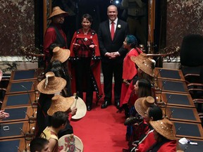 Premier John Horgan enters the legislature for a swearing-in ceremony surrounded by members of the Nisga'a First Nation in February.