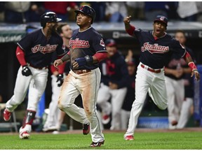 Cleveland Indians' Jose Ramirez, front, scores on a double by Jay Bruce during the 10th inning of a baseball game against the Kansas City Royals, Thursday, Sept. 14, 2017, in Cleveland. The Indians won 3-2.