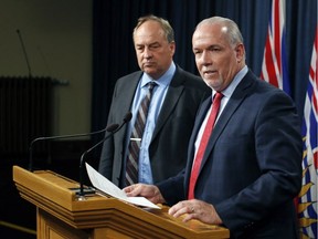 Premier John Horgan and Green party Leader Andrew Weaver speak to media following the legislation announcement banning union and corporate donations to political parties during a press conference at Legislature in Victoria, B.C., on Monday, Sept. 18, 2017.