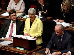 Attorney-General David Eby (left) looks on as B.C. Finance Minister Carole James delivers the budget from the legislative assembly at Legislature in Victoria on Monday, Sept. 11, 2017.