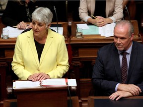 B.C. Finance Minister Carole James delivers the budget as Premier John Horgan looks on from the legislative assembly at Legislature in Victoria, B.C., on Monday, September 11, 2017.