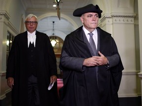 Former Liberal MLA Darryl Plecas is escorted from the speaker corridor to the legislative assembly after being elected speaker at Legislature in Victoria, B.C., on Friday, September 8, 2017.