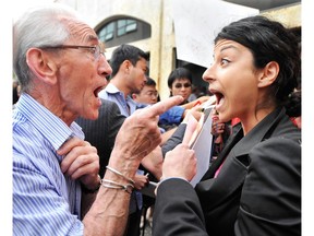 NDP supporter Brian O'Neill (left) confronts Mia Taghizadeh (right) who was protesting that a vote for NDP Leader Jack Layton is a vote for Conservative Leader Stephen Harper during a Jack Layton campaign stop at the Italian Cultural Centre in Vancouver  on September 8, 2008.