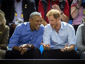 Former U.S. President Barack Obama and Prince Harry watch wheelchair basketball at the Invictus Games in Toronto on Friday, Sept. 29, 2017. THE CANADIAN PRESS/Chris Donovan