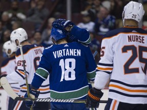 Vancouver Canucks forward Jake Virtanen is congratulated after scoring against the Edmonton Oilers during the first period of Saturday's preseason game at Rogers Arena.