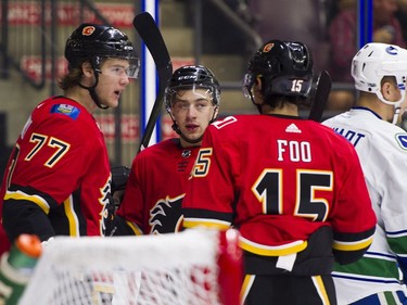 Calgary Flames Mark Jankowski (left) celebrates with Andrew Mangiapane (middle) and Spencer Foo after scoring against the Vancouver Canucks.