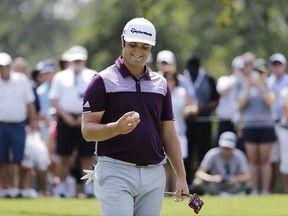 Jon Rahm, of Spain, looks at the ball after sinking a putt on the first hole during the first round of the Tour Championship golf tournament at East Lake Golf Club in Atlanta, Thursday, Sept. 21, 2017. (AP Photo/David Goldman)