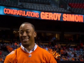 Former B.C. Lions' receiver Geroy Simon smiles during a ceremony where the CFL team retired his number 81 during halftime of their game against the Winnipeg Blue Bombers in Vancouver, B.C., on Friday July 25, 2014.