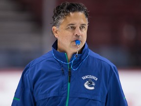 Vancouver Canucks' head coach Travis Green watches during the NHL hockey team's training camp.