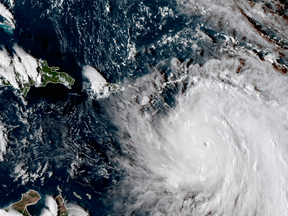 A satellite image provided shows the eye of Hurricane Maria as it nears Dominica on Monday, Sept. 18. The National Hurricane Center in Miami said Monday evening that Maria had strengthened into a storm with 160 mph winds.