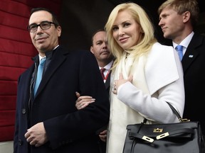 In this Friday, Jan. 20, 2017, file photo, then Treasury Secretary-designate Stephen Mnuchin and his then-fiancee, Louise Linton, arrive on Capitol Hill in Washington, for the presidential inauguration of Donald Trump. The pair married in June and reportedly sought to use military aircraft to fly to their European honeymoon.