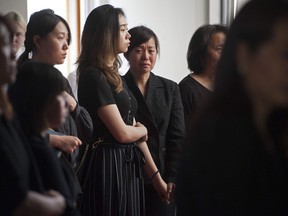 FILE PHOTO - Mourners at the funeral service for 13-year-old Marrisa Shen at Mountain View cemetery in Vancouver, BC Friday, July 28, 2017.