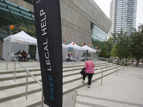 Lawyers give advice to people at a free legal advice-a-thon at Surrey City Hall in Surrey.