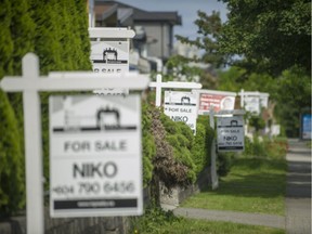 Real estate signs along Broadway near Renfrew  in Vancouver, B.C., June 12, 2017.